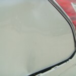 Before and after photographs of a damaged white Subaru that was repaired by Elite Paint & Body Shop in West Palm Beach, Florida